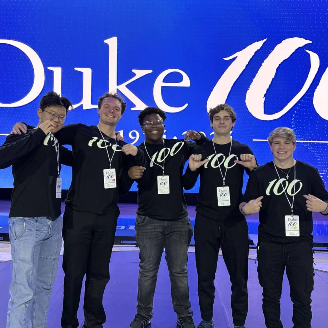 Gavin Vander Schaaf (far right) and Derrick Hamilton (middle) celebrate 100 years of Duke University